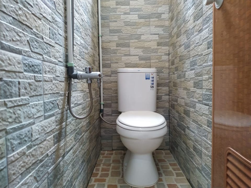 Standard Single AC Room, Shared Bathroom | Bathroom | Shower, bidet, towels