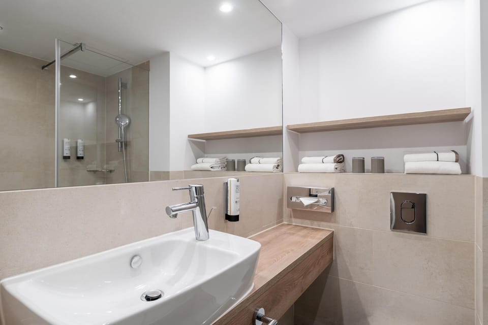 Superior Room | Bathroom | Shower, hair dryer, soap, toilet paper