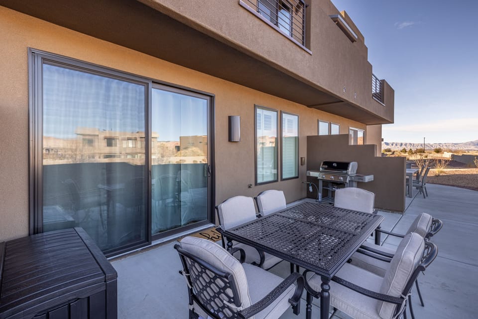 Back Patio Dining Table - The Back Patio includes an outdoor dining table, BBQ grill, and sliding glass door that leads into the living room.