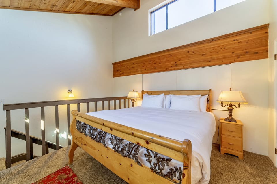 Loft bedroom has vaulted ceilings and plenty of natural light.