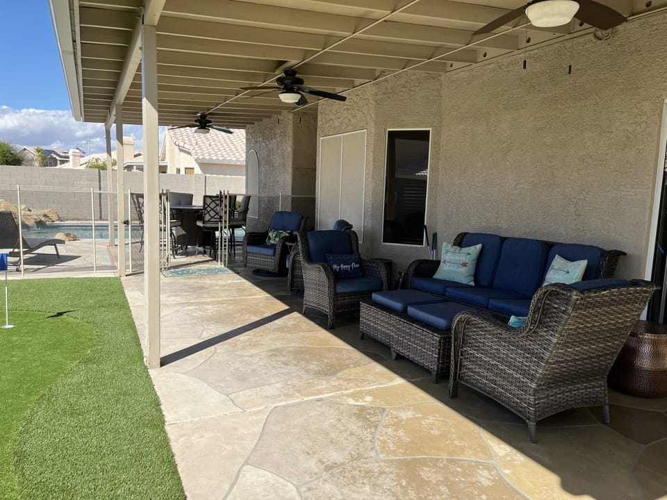 Covered Patio with lots of seating, high top fire pit table, fans & lighting. 
