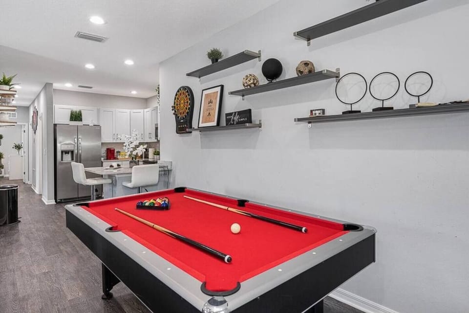 This well-appointed space is designed to offer seamless blend of entertainment options. At the heart of this area is a versatile pool table that effortlessly transforms into a ping pong table, catering to your every gaming preference.