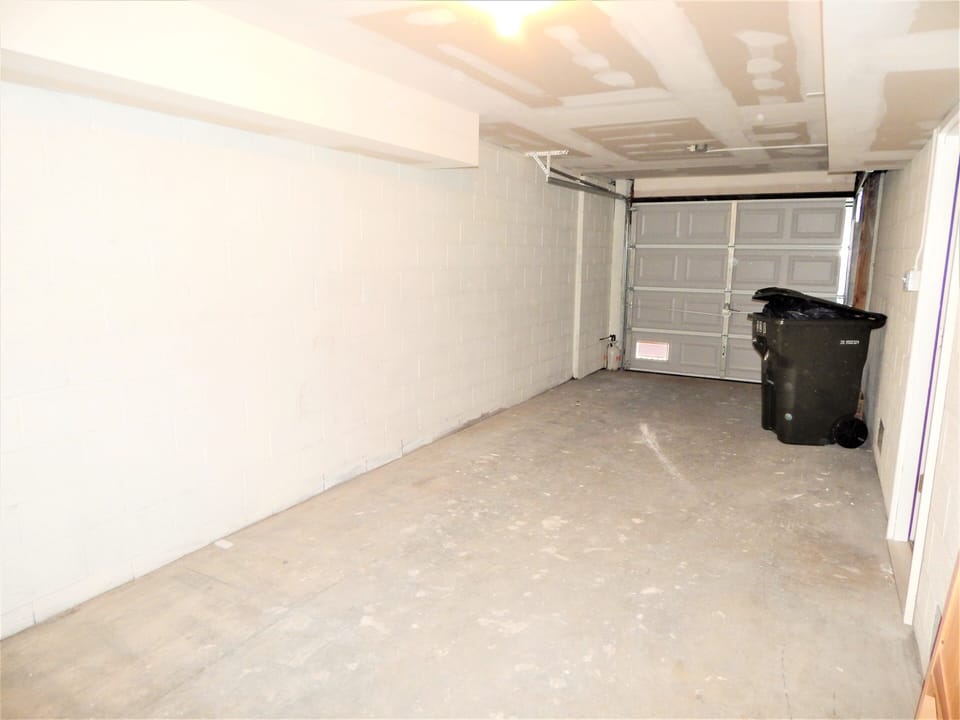 Main floor garage able to fit 1 small car in addition to 1 car driveway parking