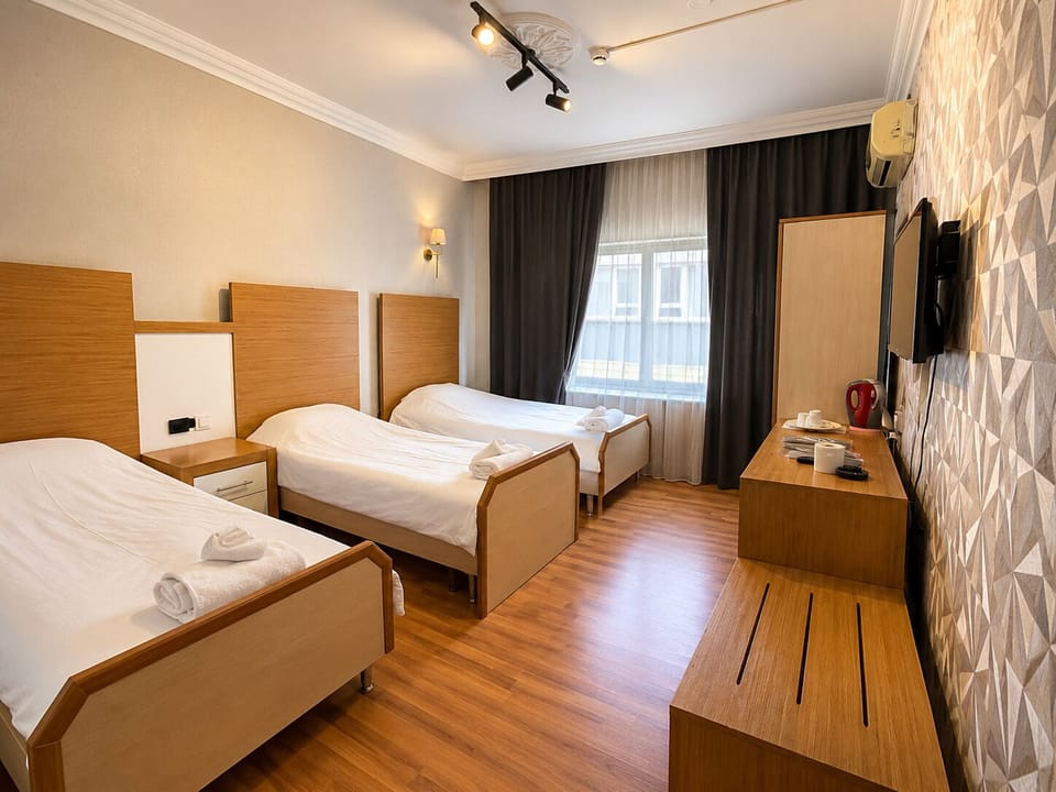 Economy Quadruple Room, 1 Bedroom | Desk, laptop workspace, blackout drapes, iron/ironing board
