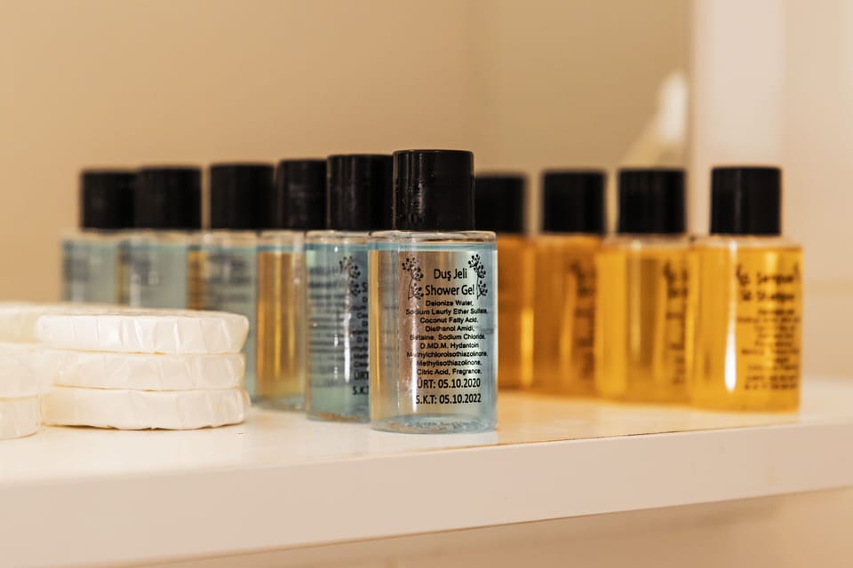 Combined shower/tub, designer toiletries, hair dryer, slippers