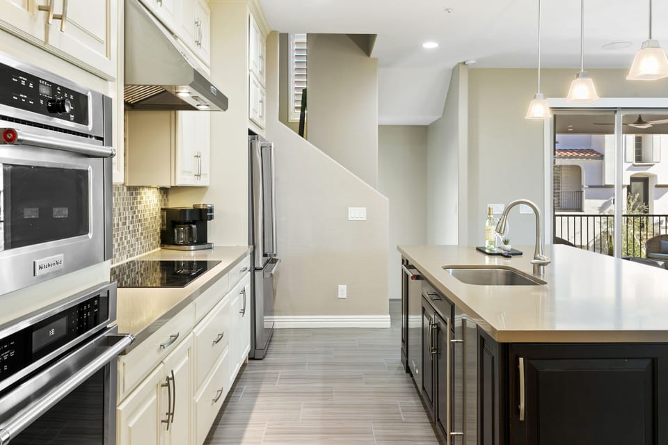 Fully stocked kitchen with high end appliances including island ice maker.