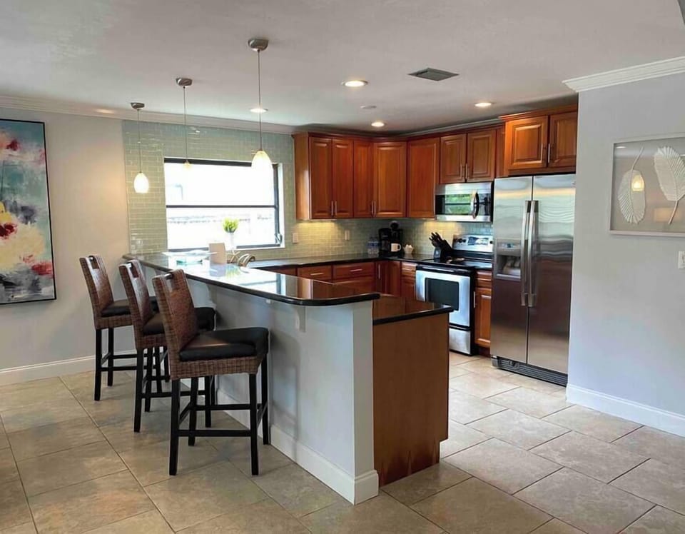 Open kitchen with bar seating for 3