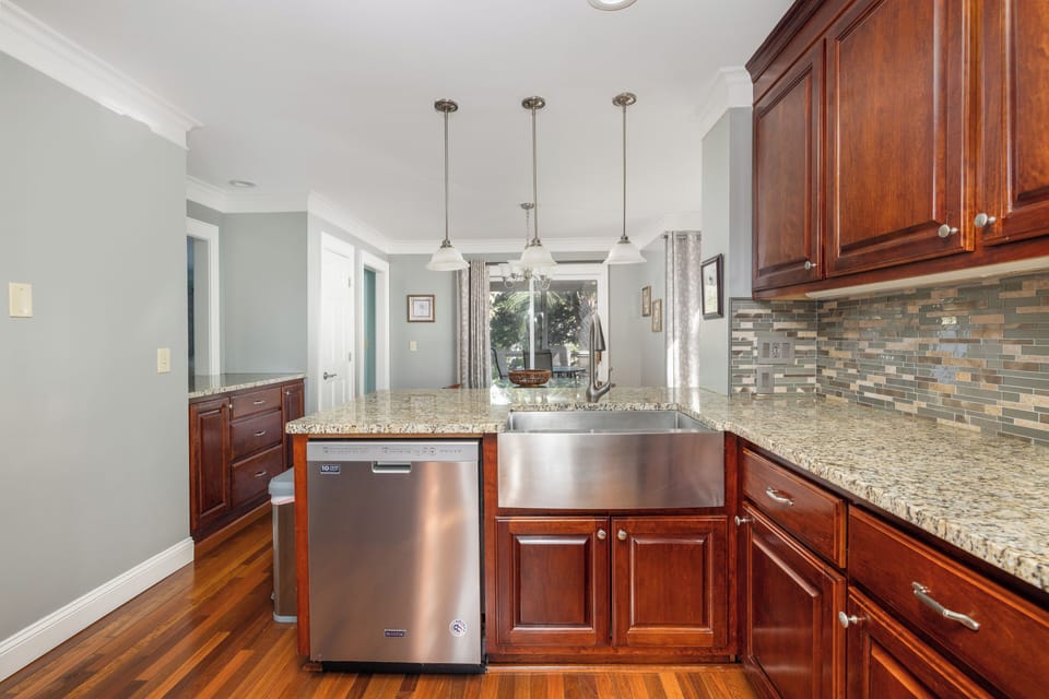 Coastal Kitchen highlighting bar seating, granite countertops
