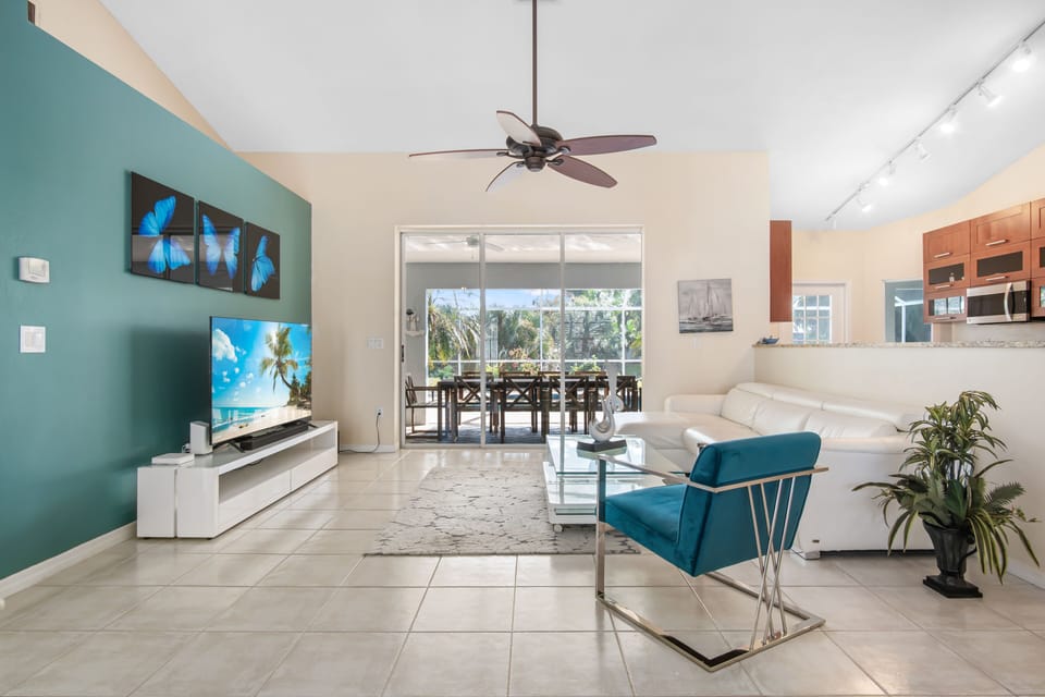Spacious modern living room with huge flat screen TV and leather sofa