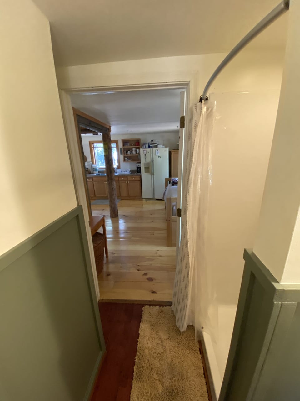 Looking out into kitchen area/spare bed from bathroom 