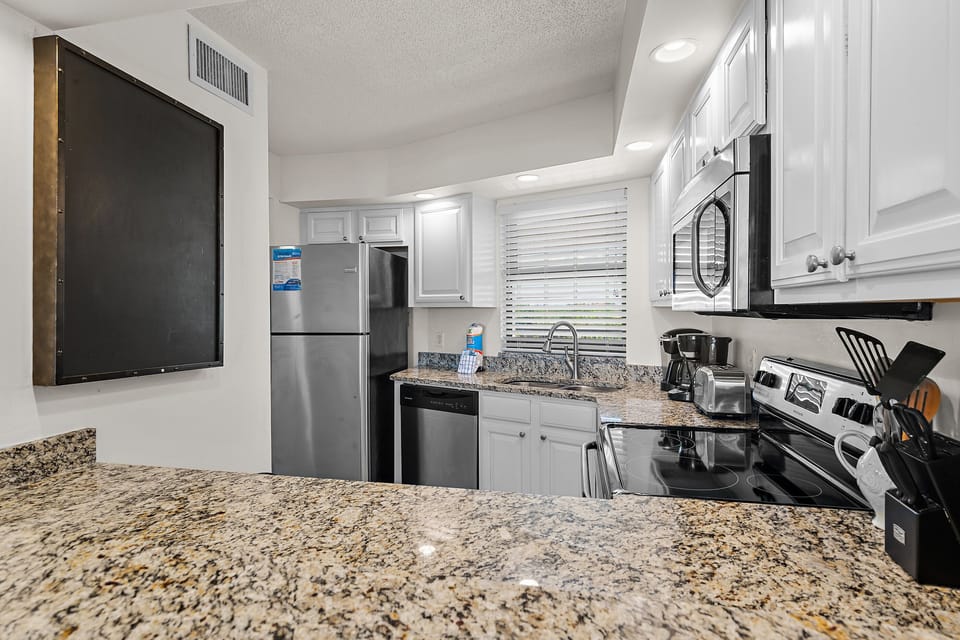 Open living and dining space with Gulf-front balcony access