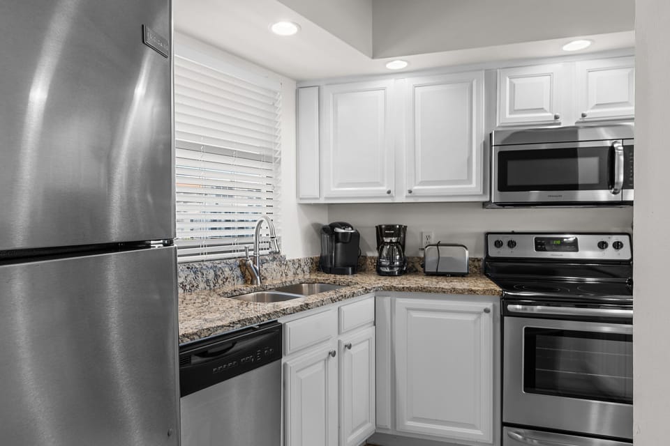 Updated kitchen with stainless steel appliances and granite countertops