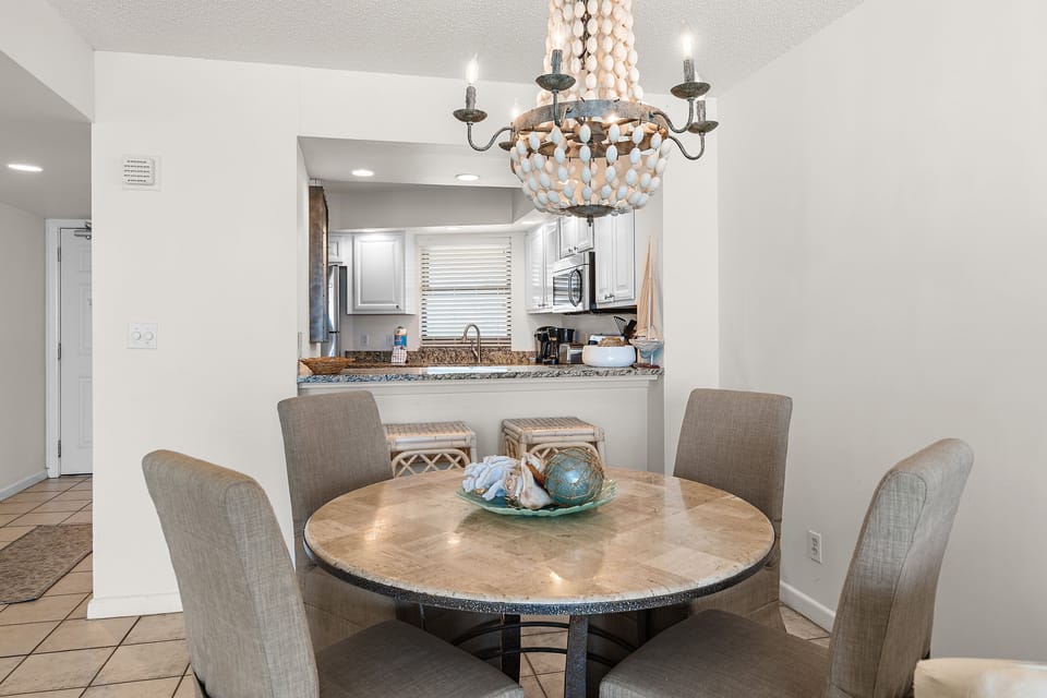 Coastal-inspired dining area adjacent to the fully equipped kitchen