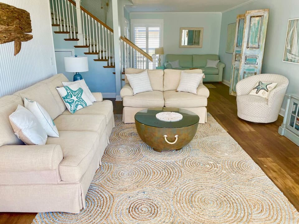 Bright living room opens to ocean views 