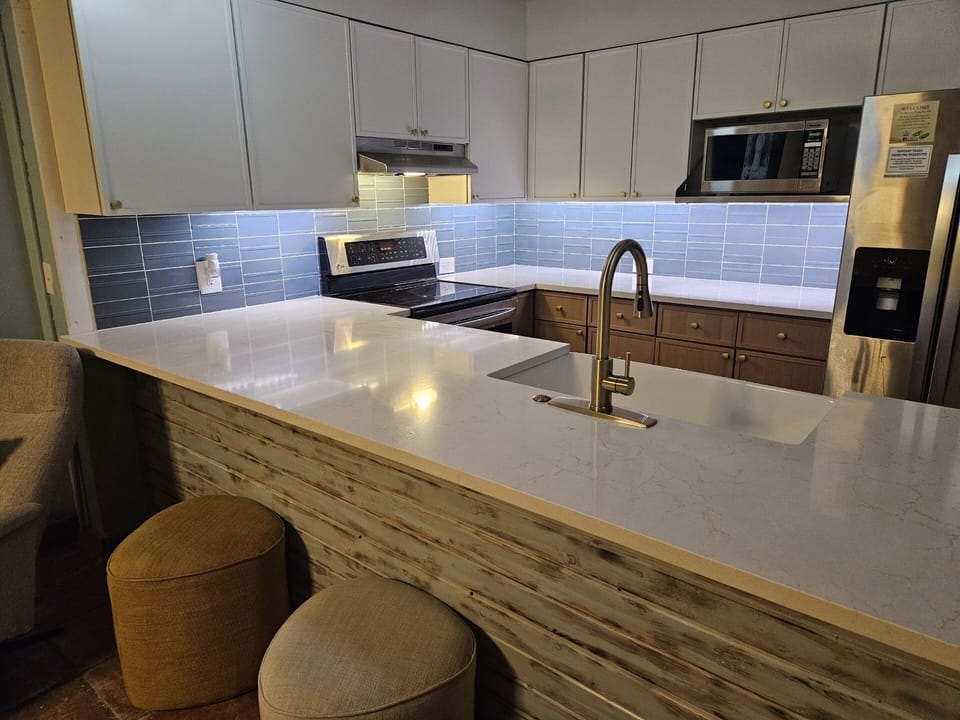 Kitchen has undercabinet lighting, plentiful counterspace