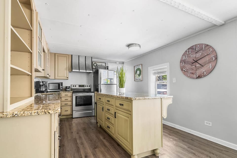 Bright, spacious kitchen with granite island and modern appliances