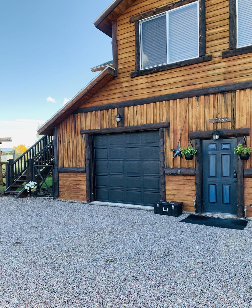 Parking in front of this garage door and stairs leading up to the rental space 