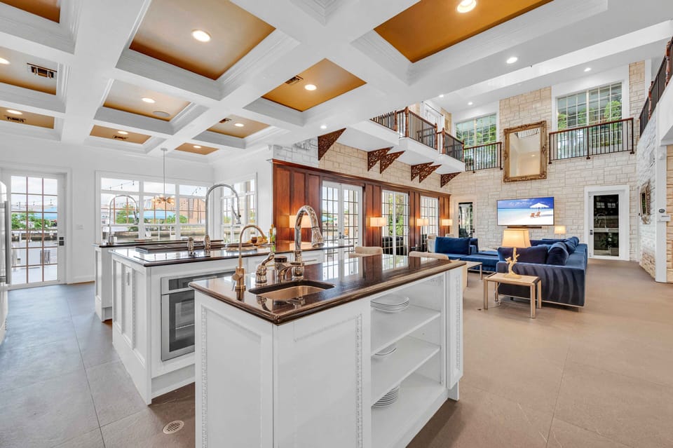 The Chef's open kitchen offering canal views features three islands and a butler's pantry and a breakfast nook.