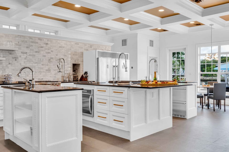 The Chef's open kitchen offering canal views features three islands and a butler's pantry and a breakfast nook.