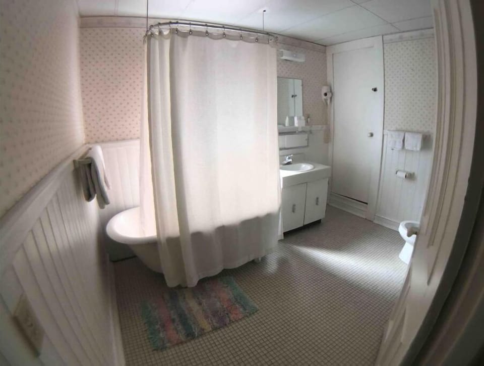 Large bathroom with claw foot tub.