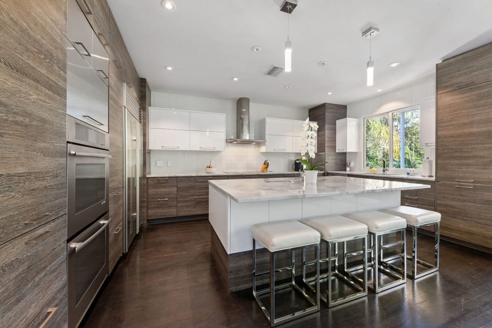 Kitchen features double oven,induction cooktop, sub zero refrigerator, ice maker