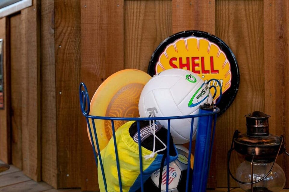 Game in with volleyball, soccer ball, and frisbee