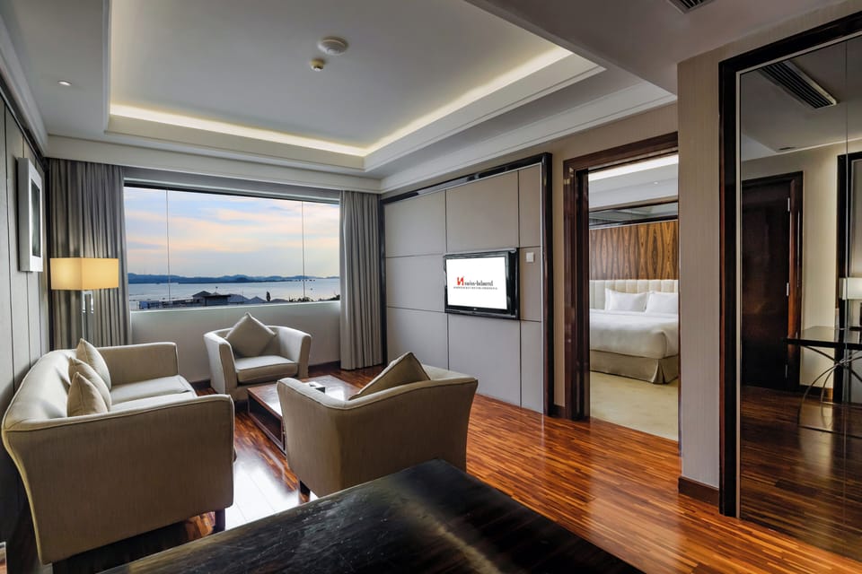 Junior Suite, 1 King Bed | Living area | 32-inch LCD TV with cable channels, TV, DVD player