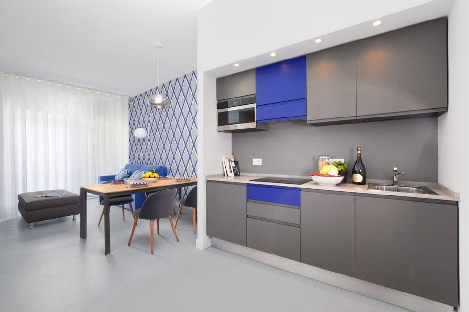 Design Apartment | Private kitchen | Microwave, spices, cleaning supplies, dining tables