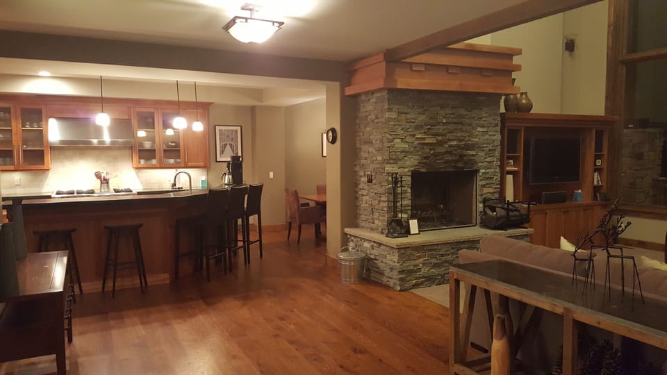 Kitchen and living area with wood burning fireplace