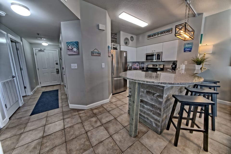 Spacious kitchen with new appliances and seating at the bar 