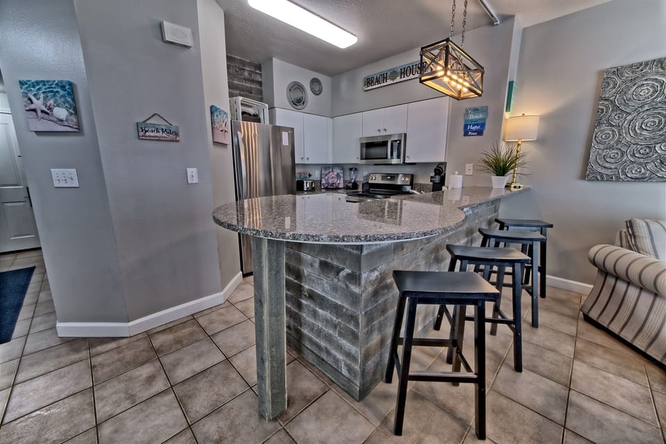 Spacious kitchen with new appliances and seating at the bar 
