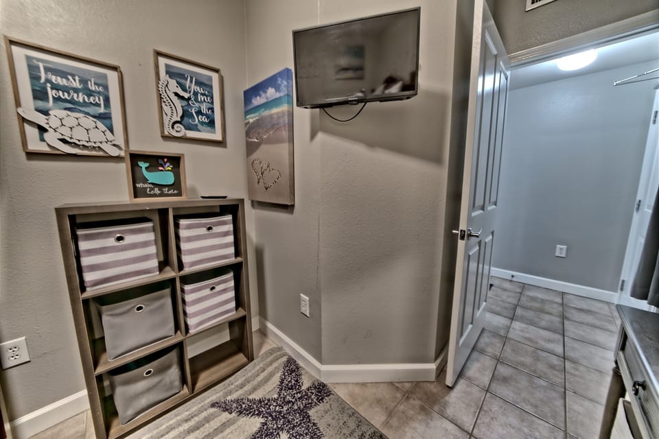 Bunkroom has a set of twin beds with a smart tv