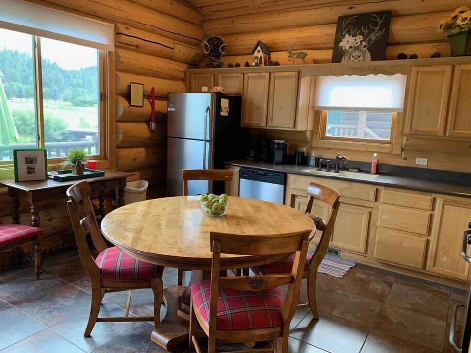 Our round dining table provides seating for 4 & 1 extra chair can be used at the desk or for dining. Great view from the porch while telecommuting overlooks a large grassy meadow & mountain scenery to the East. We have screens in all windows.