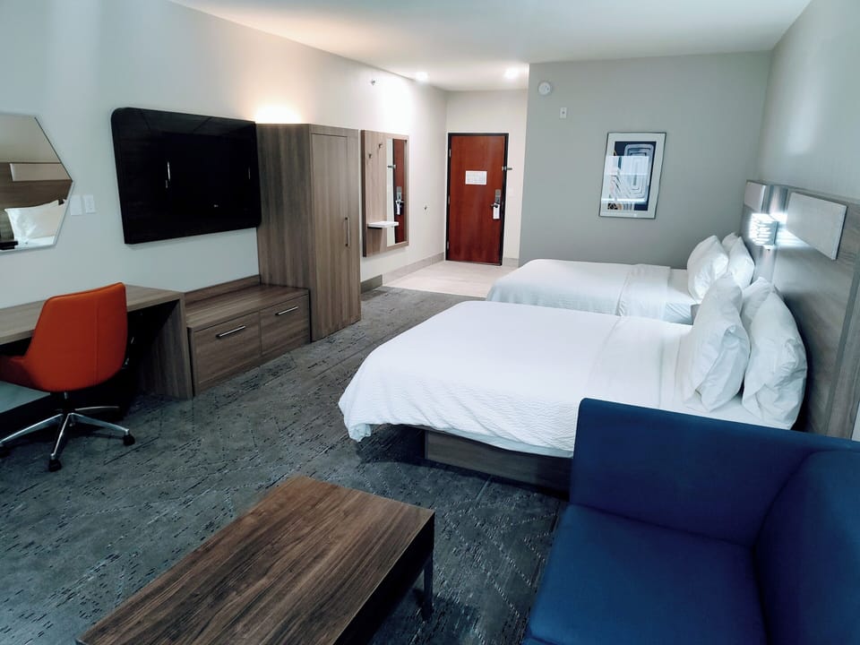 Suite, 2 Queen Beds | Living area | 55-inch LCD TV with satellite channels, TV