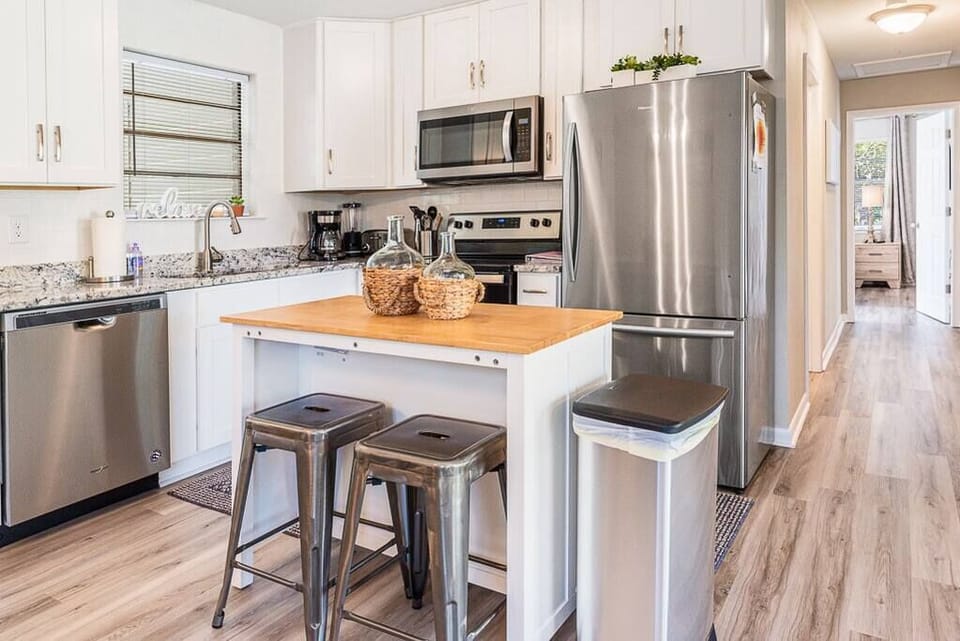 Kitchen has all stainless steel appliances and a woodblock island for extra space to meal prep!