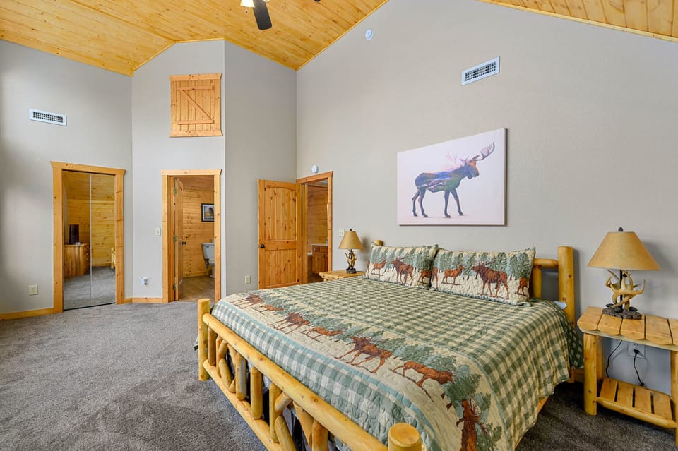 Huge master bedroom with custom log wood king bed, 40" HD TV & walk in closet!