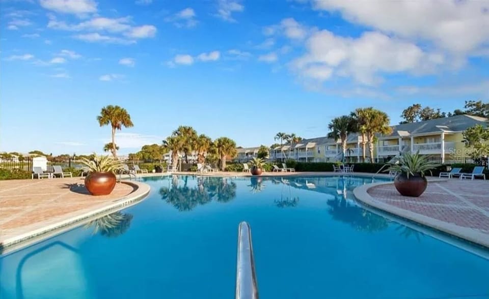 Great pool area with comfortable recliners, tables, chairs, umbrellas