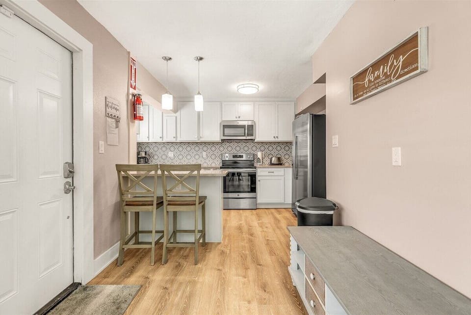 Bright and inviting entryway opens to a fully equipped kitchen designed for comfort and convenience.