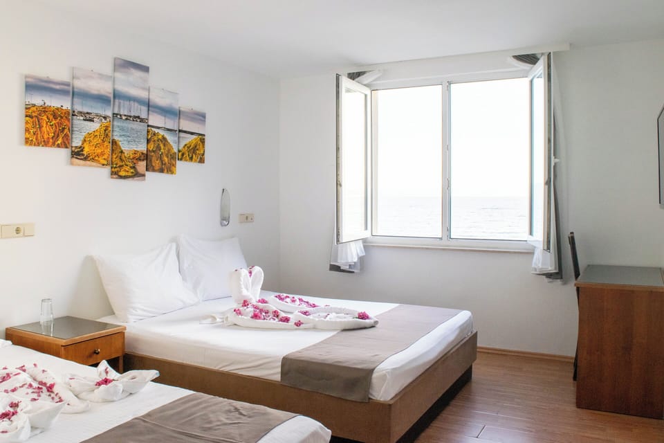 Standard Room, Multiple Beds, Sea View | In-room safe, desk, iron/ironing board, free WiFi