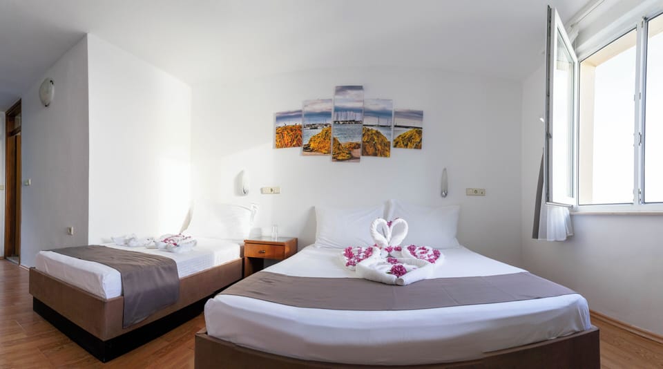 Standard Room, Multiple Beds, Sea View | In-room safe, desk, iron/ironing board, free WiFi