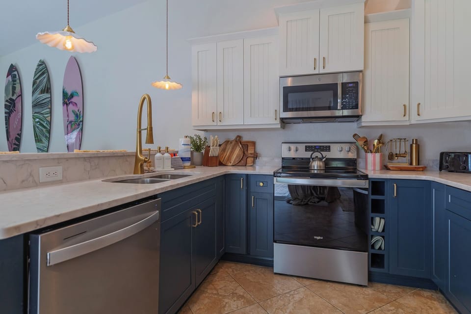 Prepare fresh coastal meals in your stylish, fully-equipped kitchen featuring stainless steel appliances, ample counter space, and charming surf-inspired accents that set a relaxed, beachy tone.