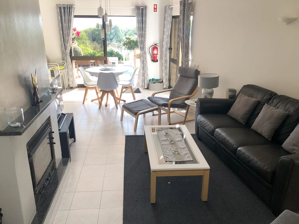 Lounge and dining area with view out to pool 