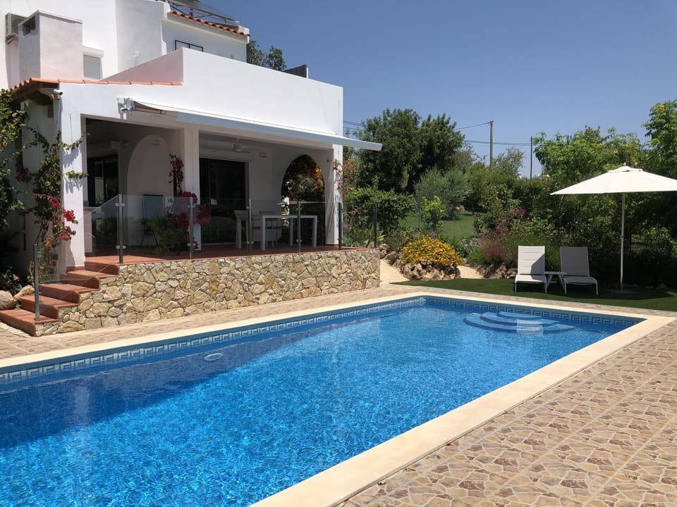Terrace and sunbeds next to pool