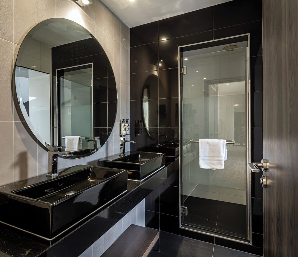Prestige Suite | Bathroom | Designer toiletries, hair dryer, bathrobes, slippers