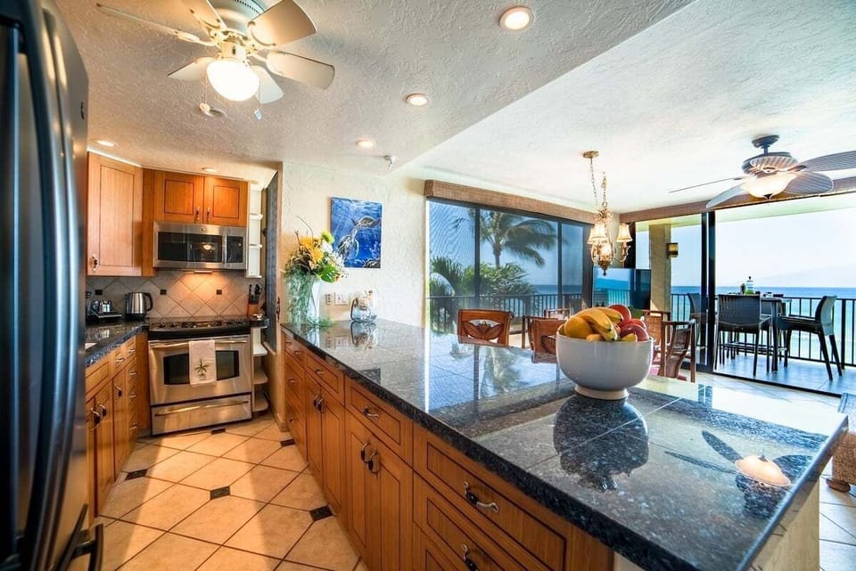 Cook with ease in a sleek kitchen framed by oceanfront scenery.