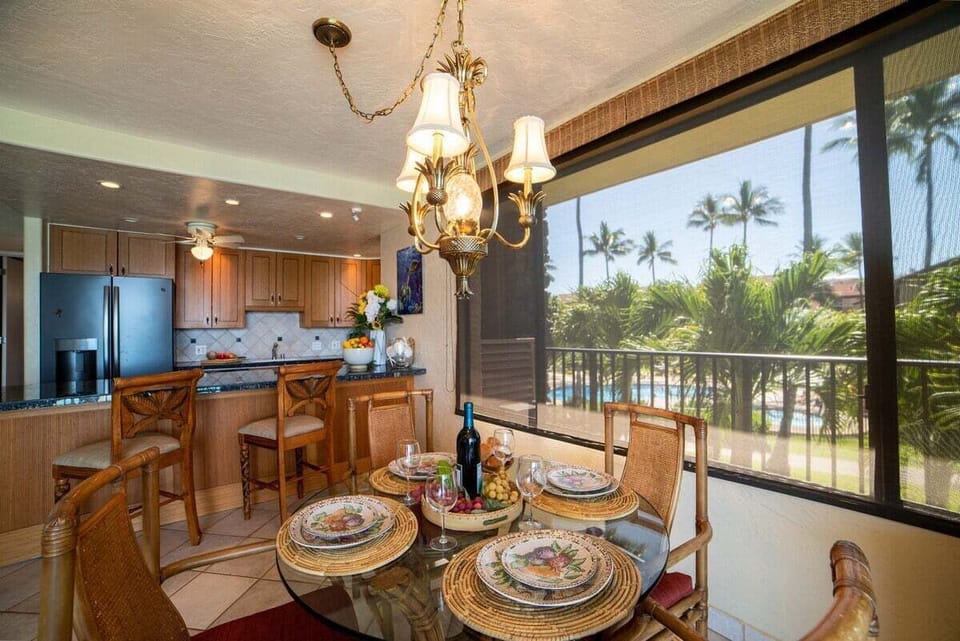 Share meals in a bright dining space framed by palm and ocean views.
