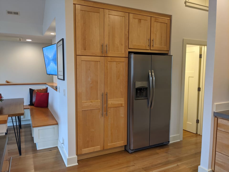 Master bedroom is to the right, the half bath door is visible with the light on.