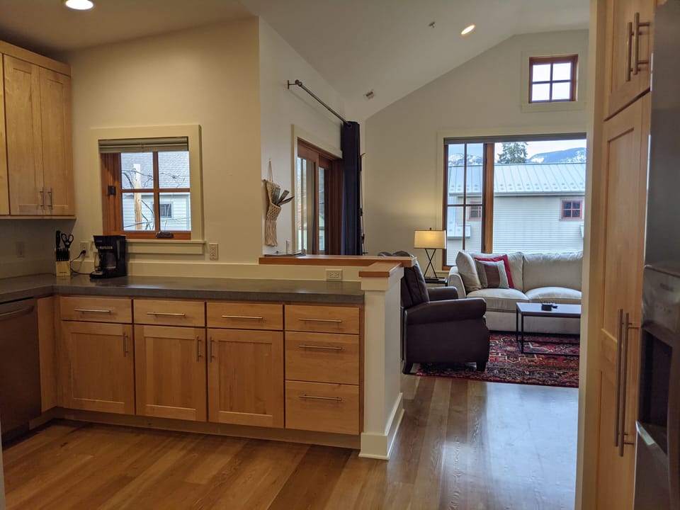 The kitchen looks into the living room.