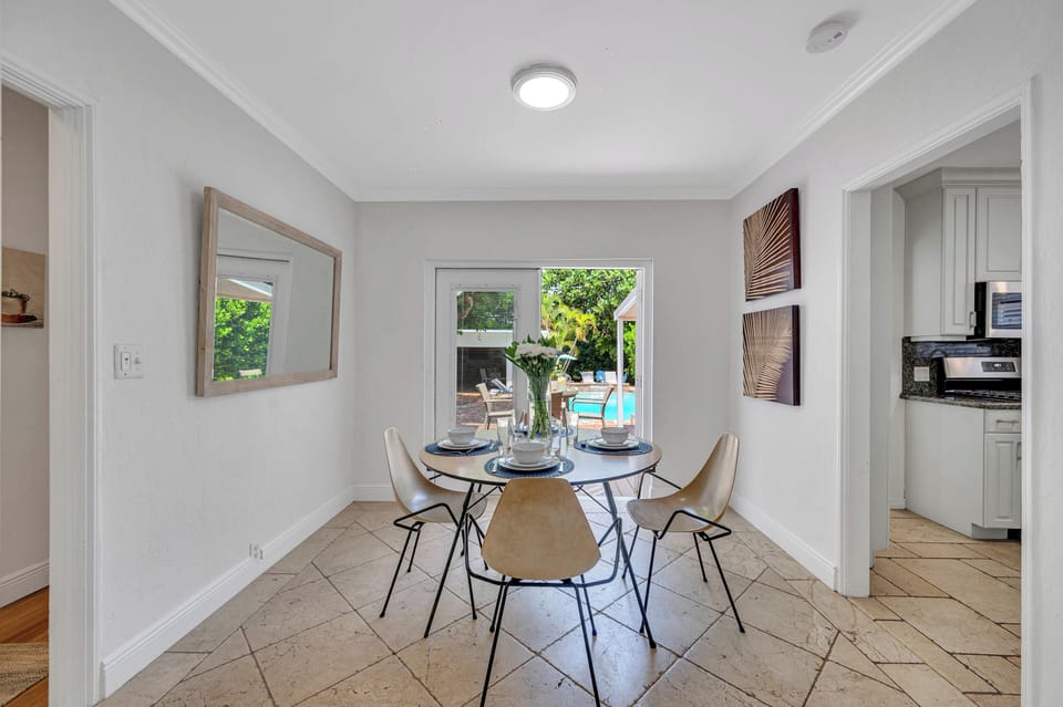 The dining table has a great view of the backyard featuring the 24/7 heated pool.