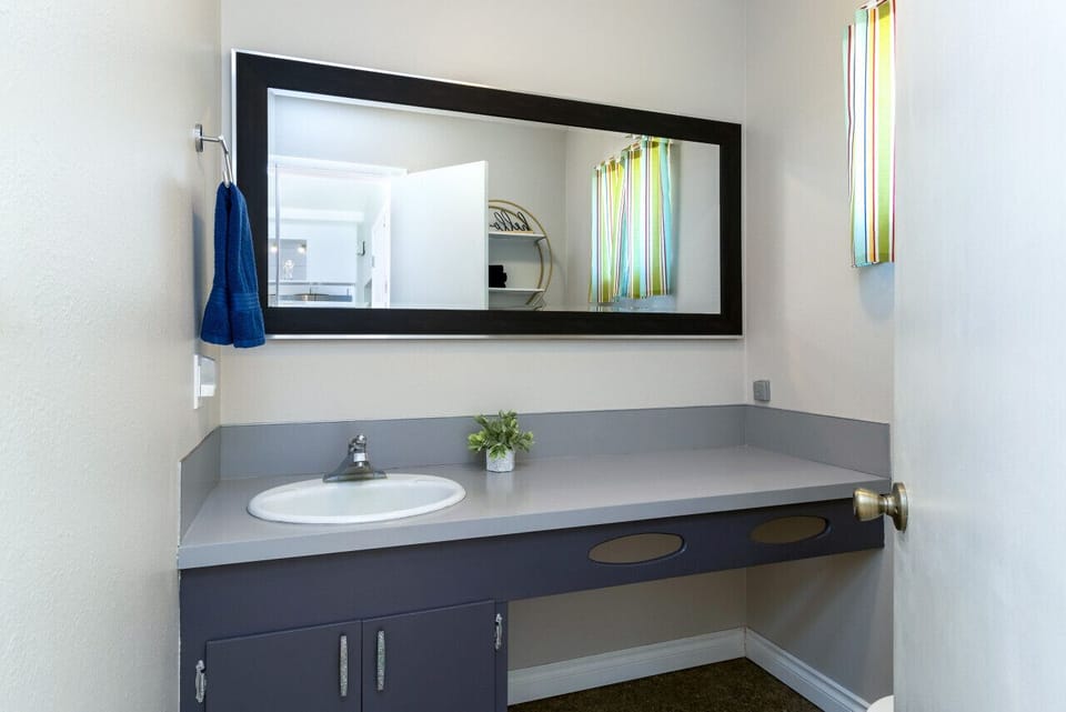 Powder room (toilet, sink) off of kitchen/dining